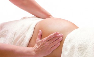 Young pregnant woman receiving relaxing massage