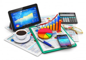 Creative abstract mobile office, stock exchange market trading, statistics accounting, financial development and banking business concept: modern tablet computer PC and black glossy touchscreen smartphone or mobile phone with stock market application software, growth bar chart and pie diagram, ballpoint pen, electronic calculator, golden eyeglasses, report documents and cup of fresh hot coffee drink isolated on white background